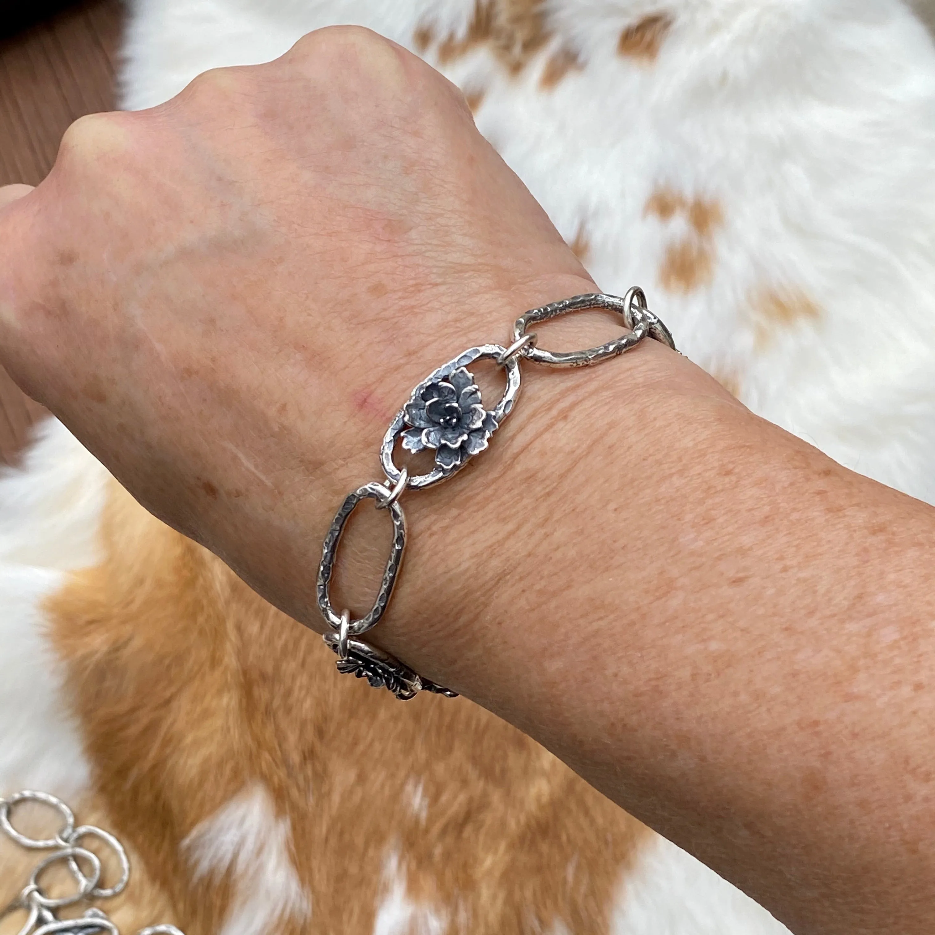 Hammered ovals with Succulent blooms. Hand cast sterling silver bracelet