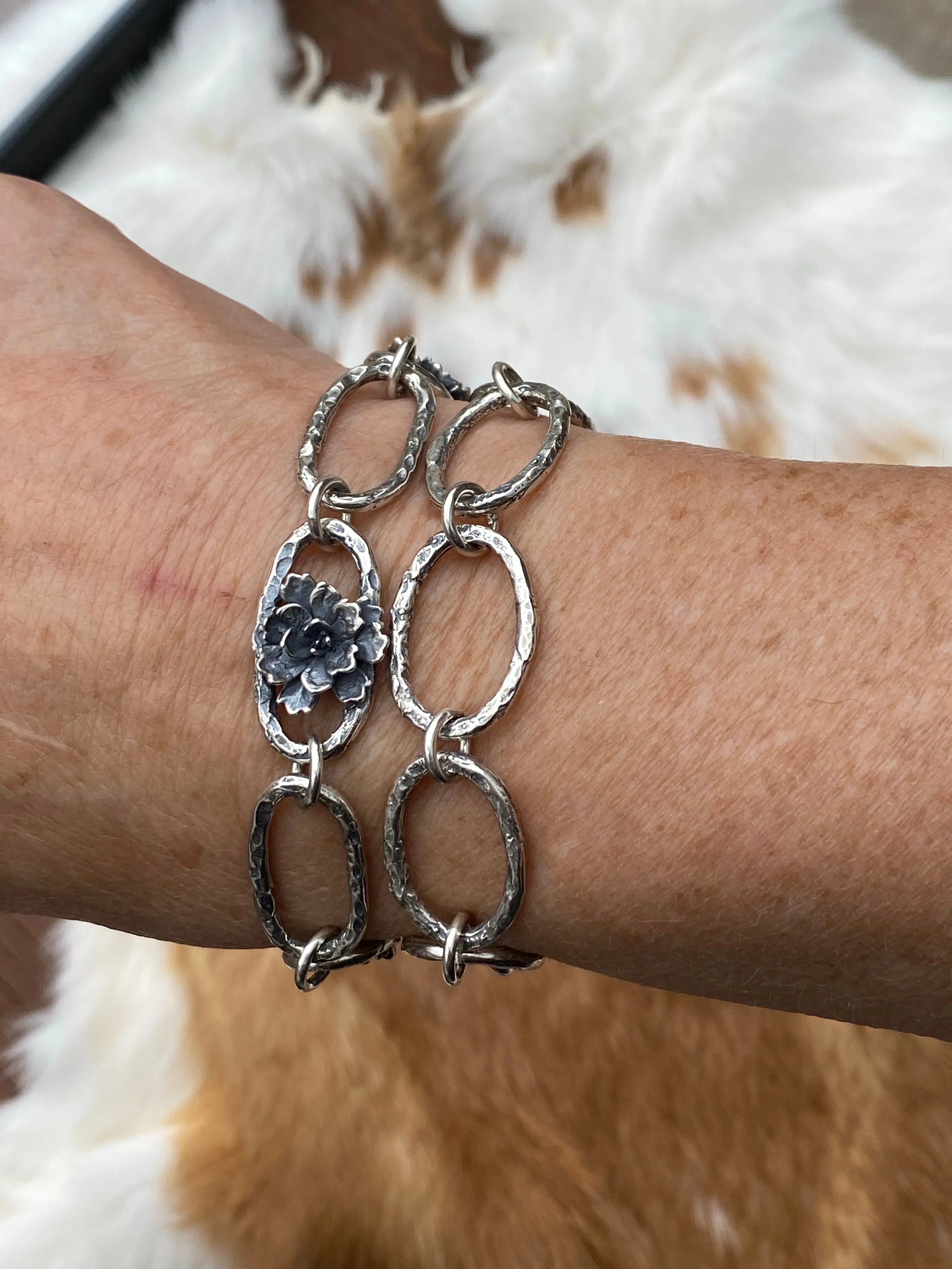 Hammered ovals with Succulent blooms. Hand cast sterling silver bracelet
