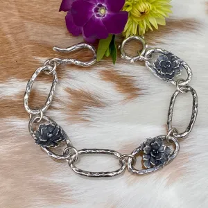 Hammered ovals with Succulent blooms. Hand cast sterling silver bracelet