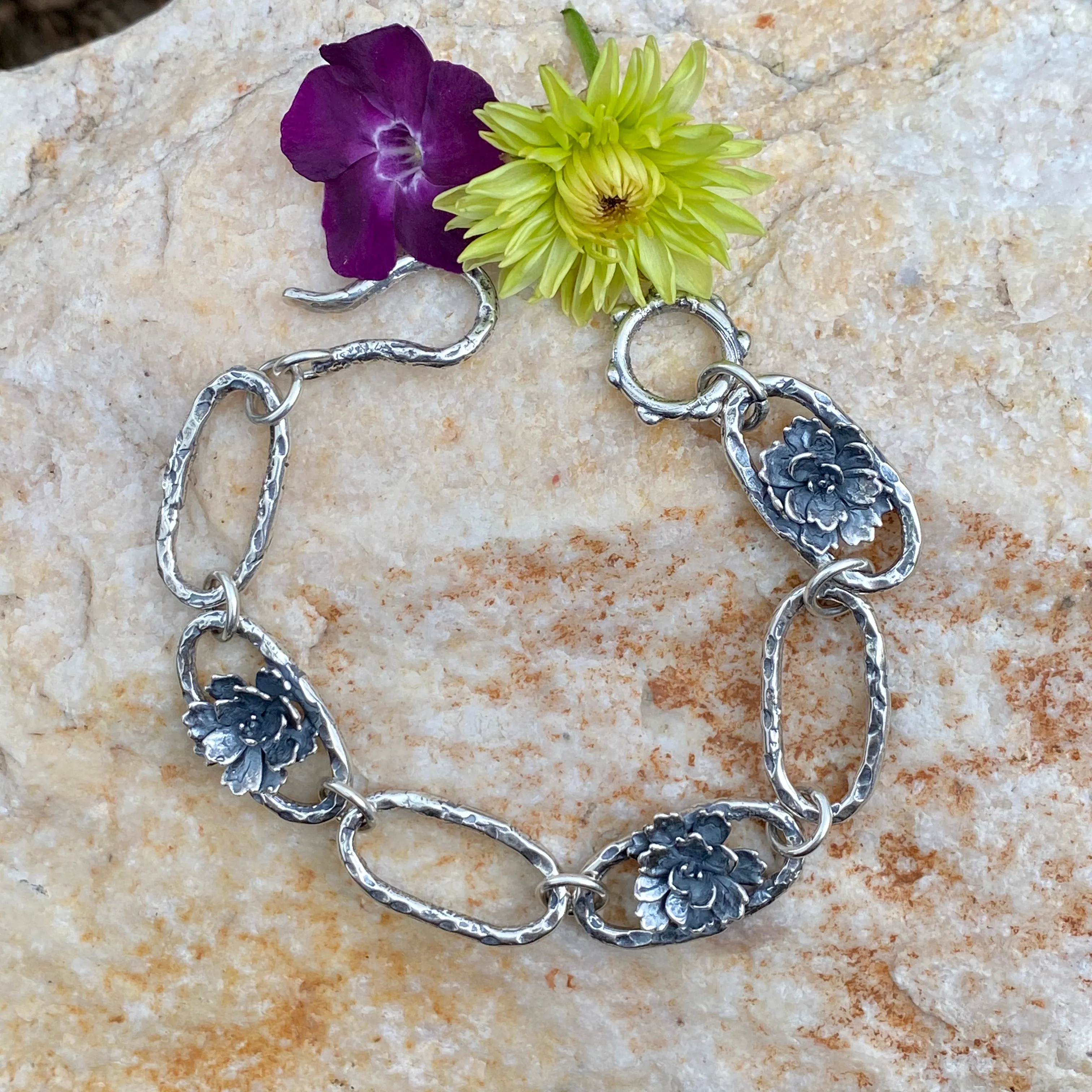 Hammered ovals with Succulent blooms. Hand cast sterling silver bracelet